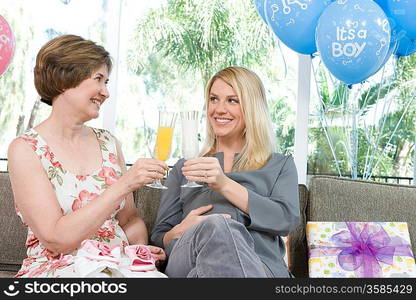 Two Women toasting drinks at a Baby Shower