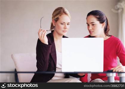 Two women using laptop computer