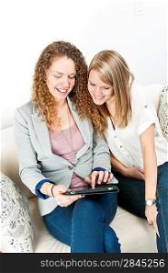 Two women using tablet computer
