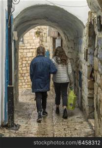 Two women walking through archway, Safed, Northern District, Israel