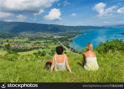 Two women watching the view of Lake Annecy