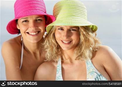 Two women wearing bikinis and hats