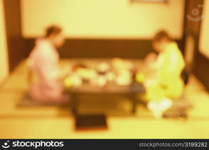 Two women wearing Kimonos and sitting together, Tokyo, Japan