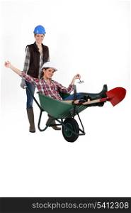 Two women with wheelbarrow