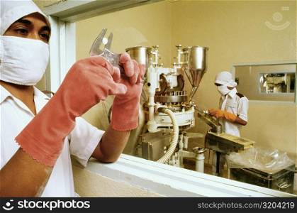 Two women working in a pharmaceutical industry, Malaysia