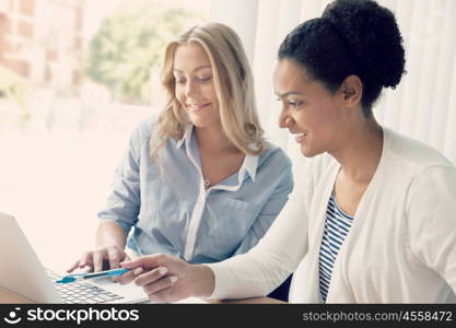 Two women working together in office