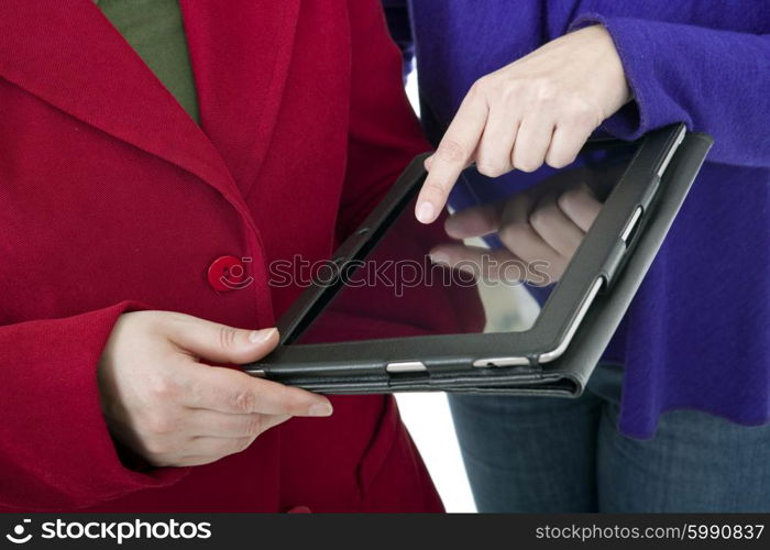 Two women working with a digital tablet, detail