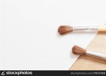 two wooden brush on a white blank sheet of paper. background