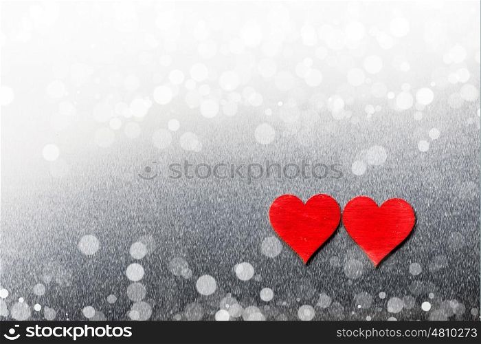 Two wooden hearts. Two red wooden hearts on metal background with copy space
