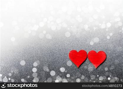 Two wooden hearts. Two red wooden hearts on metal background with copy space