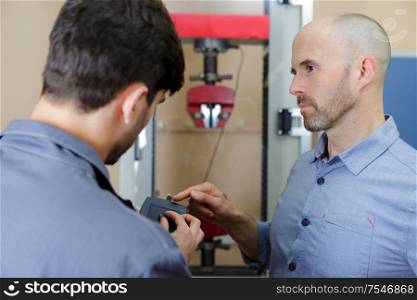 two workers in an engineering workshop