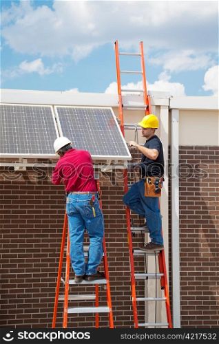 Two workers installing solar panels on the side of a building. Vertical with room for text.
