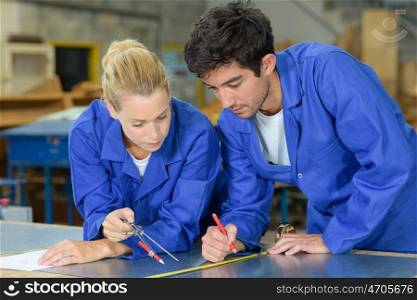 two workers making a new design