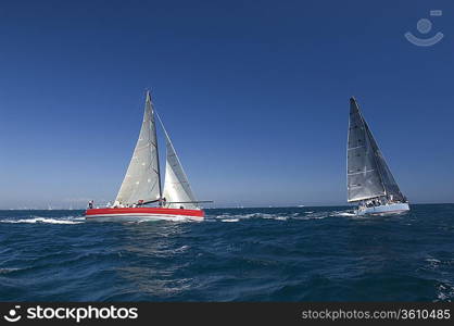 Two yachts compete in team sailing event California