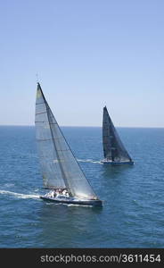 Two yachts compete in team sailing event California