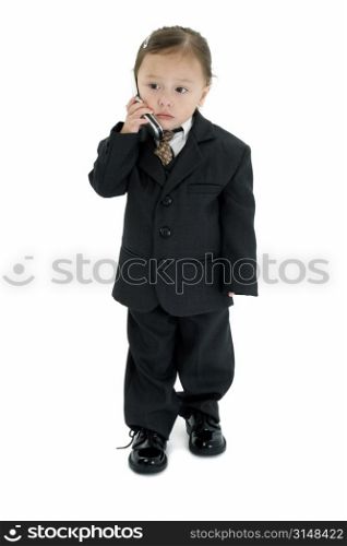 Two year old Japanese American girl in suit and tie with cellphone.