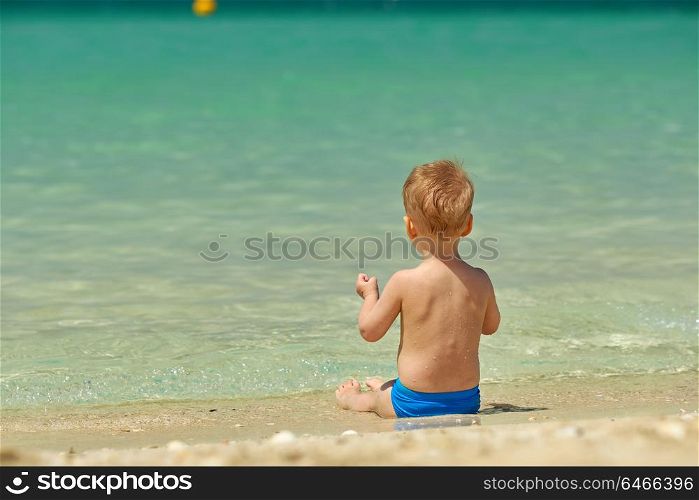 Two year old toddler boy on beach