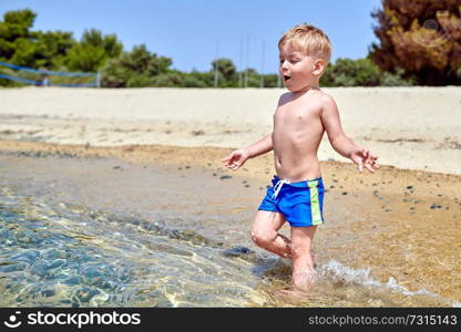 Two year old toddler boy on beach 