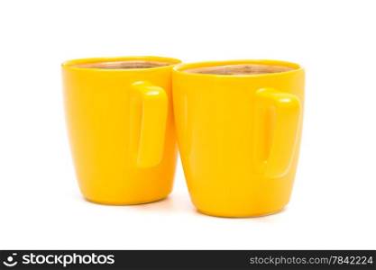 two yellow mugs of coffee on a white background
