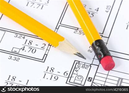 two yellow pencils on the building plan