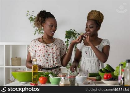 Two Young African Women Cooking. Healthy Food - Vegetable Salad. Diet. Dieting Concept. Healthy Lifestyle. Cooking At Home. Prepare Food
