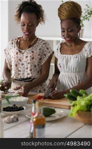 Two Young African Women Cooking. Healthy Food - Vegetable Salad. Diet. Dieting Concept. Healthy Lifestyle. Cooking At Home. Prepare Food