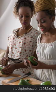 Two Young African Women Cooking. Healthy Food - Vegetable Salad. Diet. Dieting Concept. Healthy Lifestyle. Cooking At Home. Prepare Food