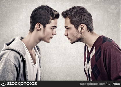 Two young angry people standing face to face