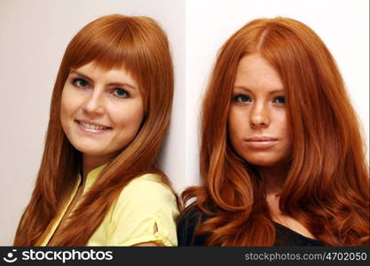 Two young beautiful redhead women