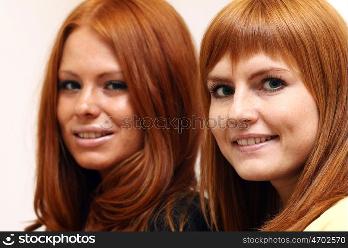 Two young beautiful redhead women