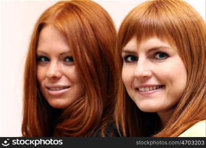 Two young beautiful redhead women