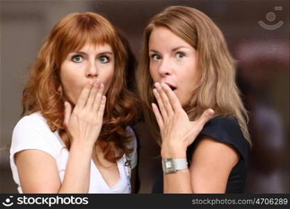 two young beautiful women are very surprised