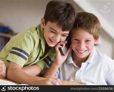 Two Young Boys Calling Someone On A Cellphone