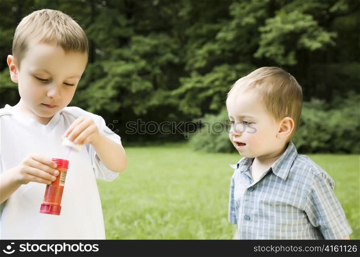 Two Young Brothers Playing Outdoors