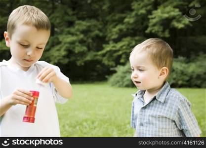 Two Young Brothers Playing Outdoors
