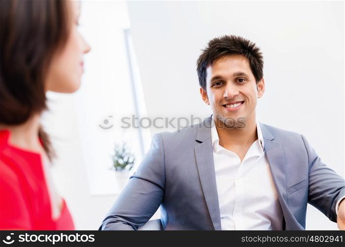 Two young business collegue talking in office. Two young business collegue in office