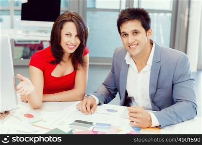 Two young business collegue working together in office. Two young business collegue in office