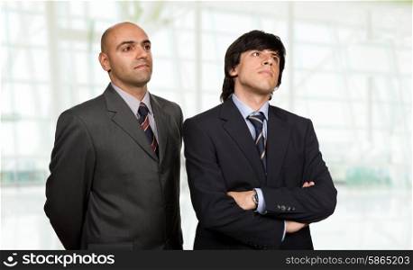 two young business men thinking, at the office