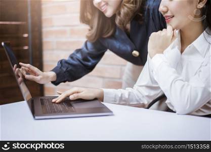 Two young business women are analytics information on laptop screen, business meeting . Two young business women are analytics information on laptop screen, business meeting concept