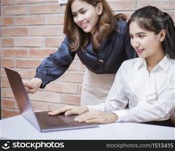 Two young business women are analytics information on laptop screen, business meeting . Two young business women are analytics information on laptop screen, business meeting concept