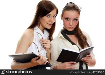 Two young business womenstanding against white background