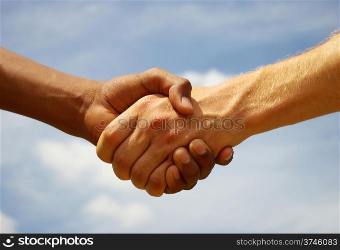 Two young businessmen shaking hands