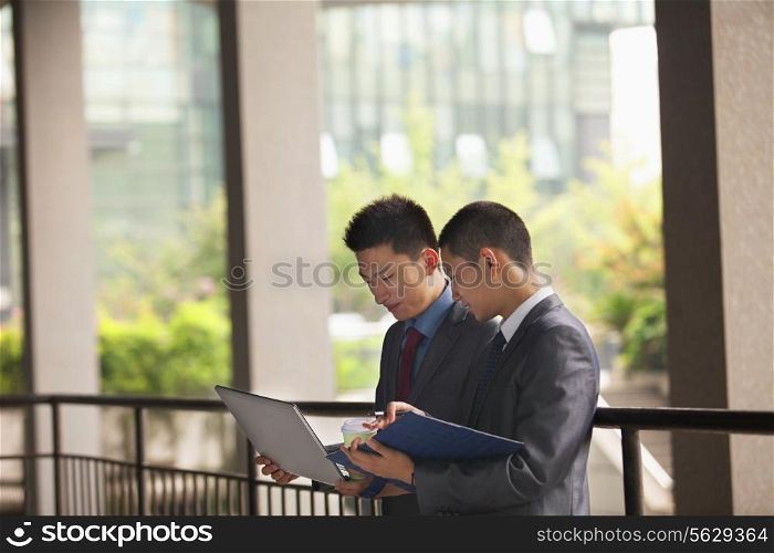 Two young businessmen working outdoor