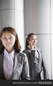 Two young businesswomen outside, portrait