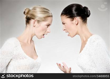 two young caucasian women arguing, studio shot