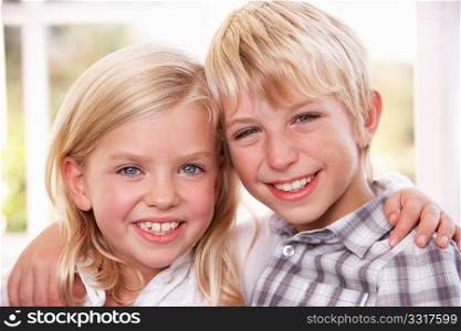 Two young children pose together;