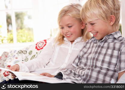 Two young children read together