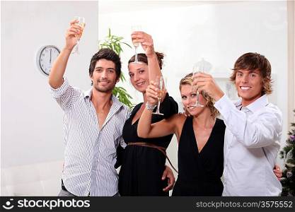 Two young couples drinking champagne