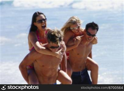 Two young couples on the beach
