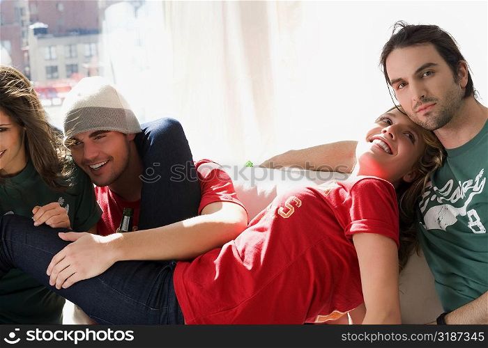 Two young couples sitting on a couch